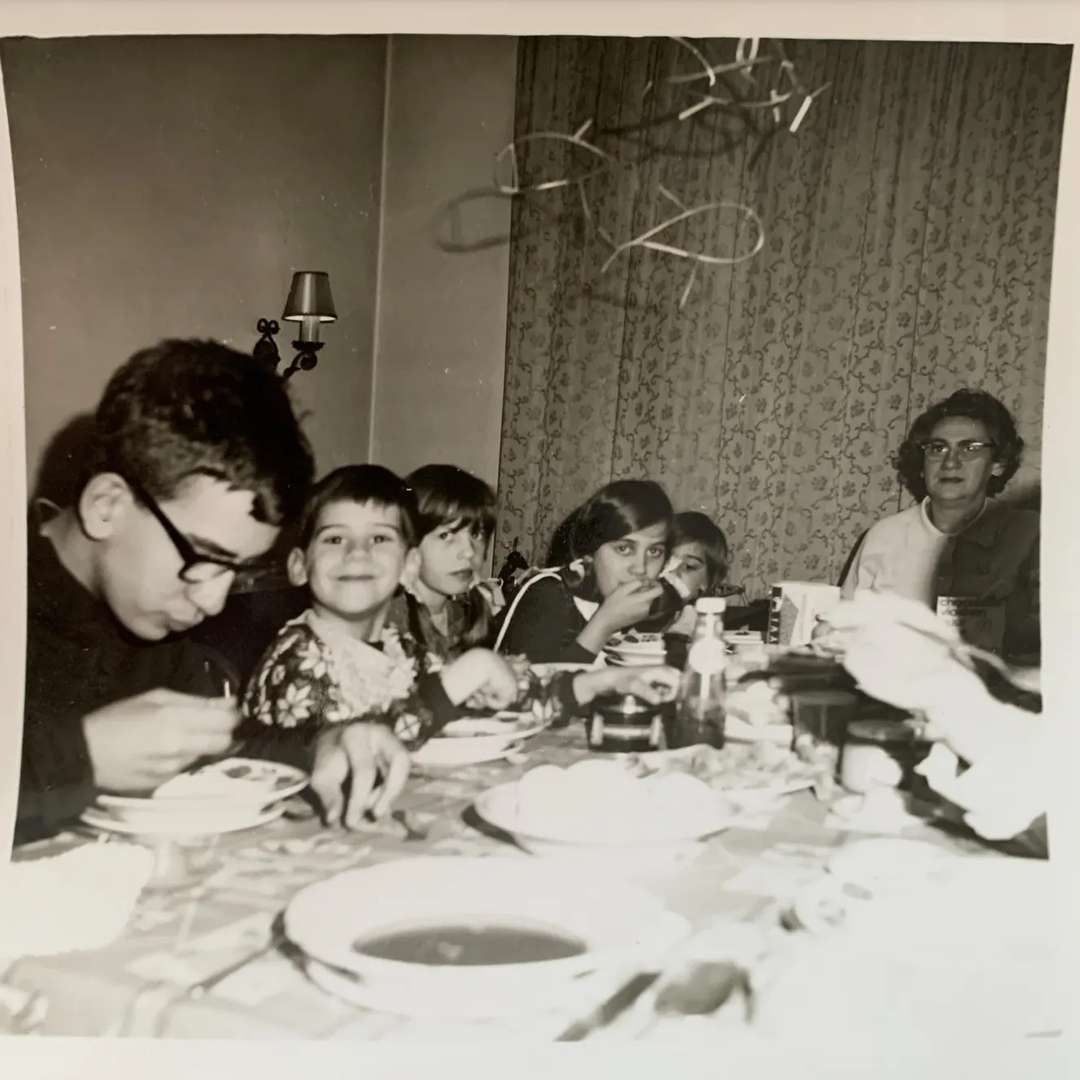 a old picture of Tom with his mom, brothers and sisters