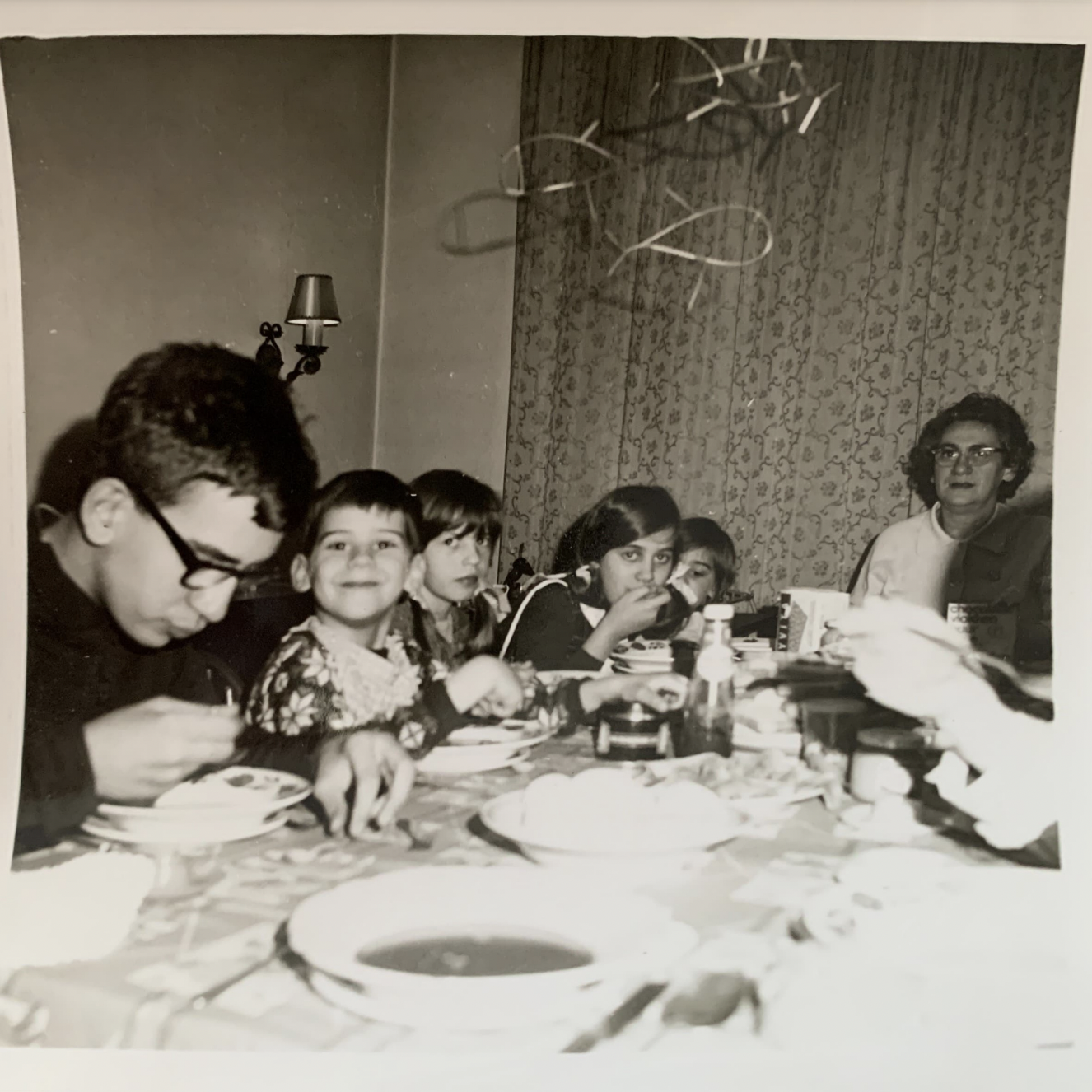a old picture of Tom with his mom, brothers and sisters